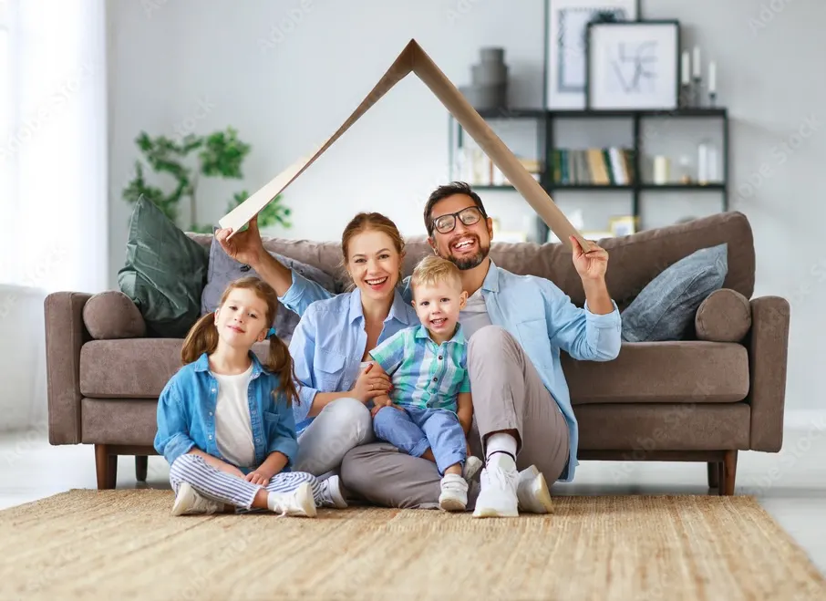 Happy family in front of their new home